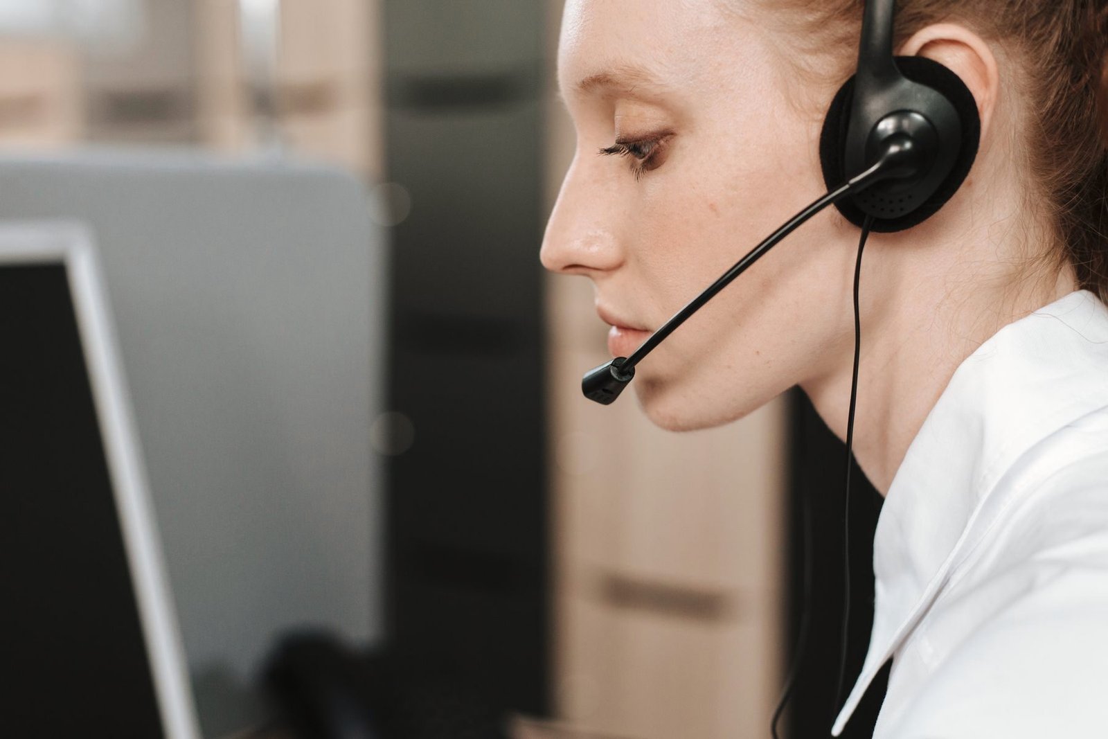 Close view of an operator on a headset call.