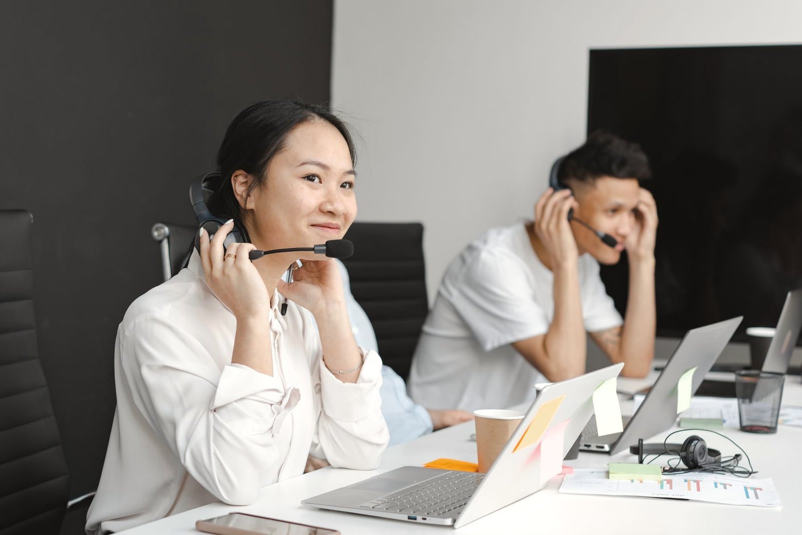 An operator at a desk wearing a headset.