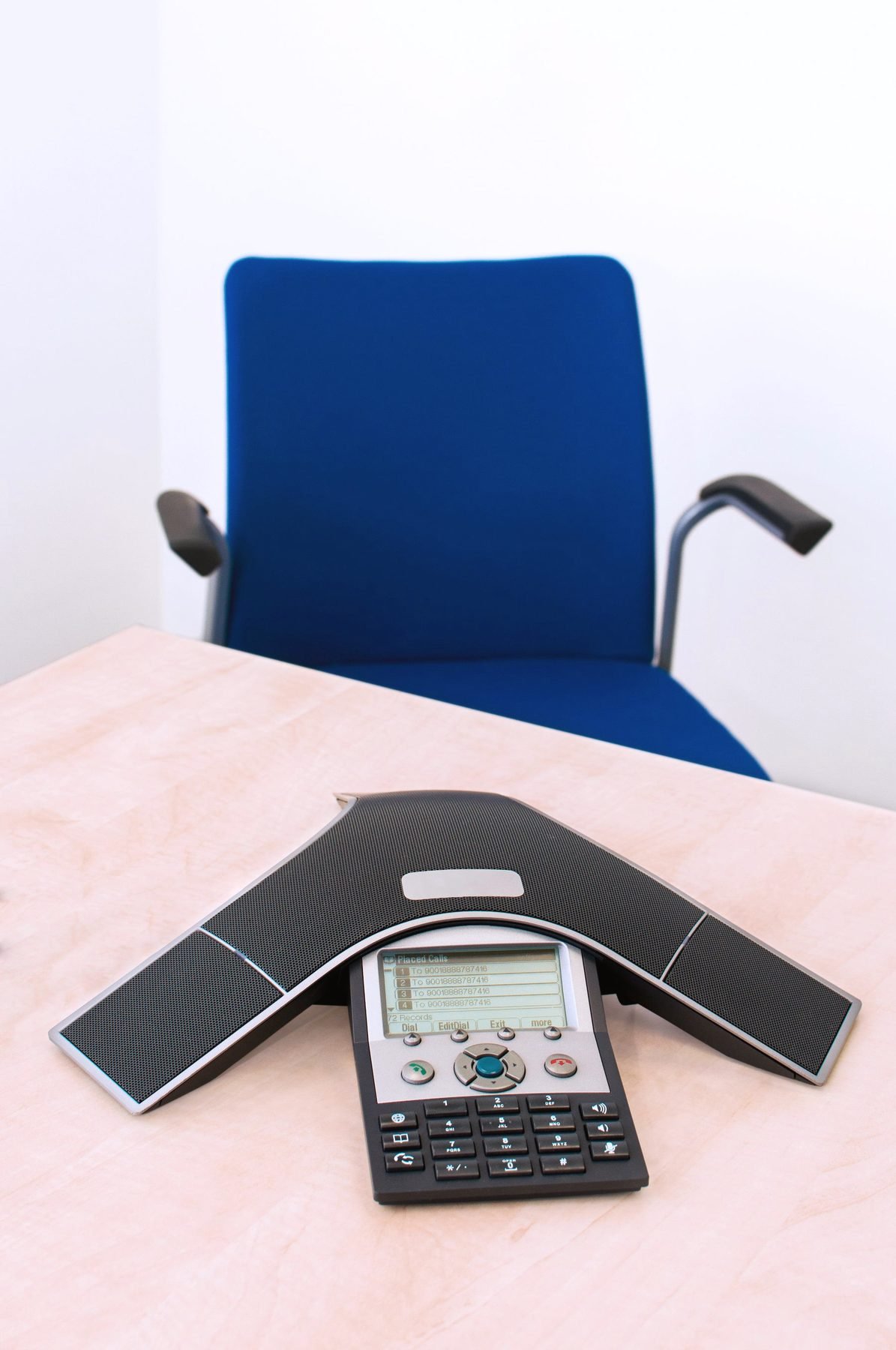 A conference telephone on an office desk.