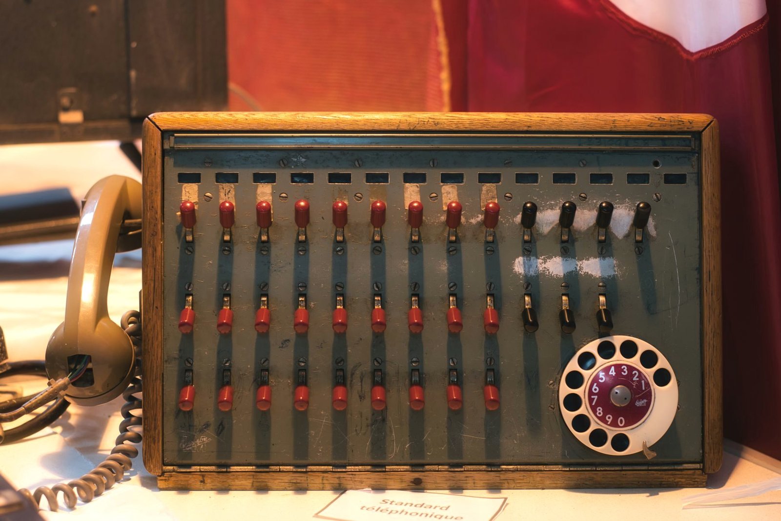 A vintage telephone switchboard with brass connection jacks.