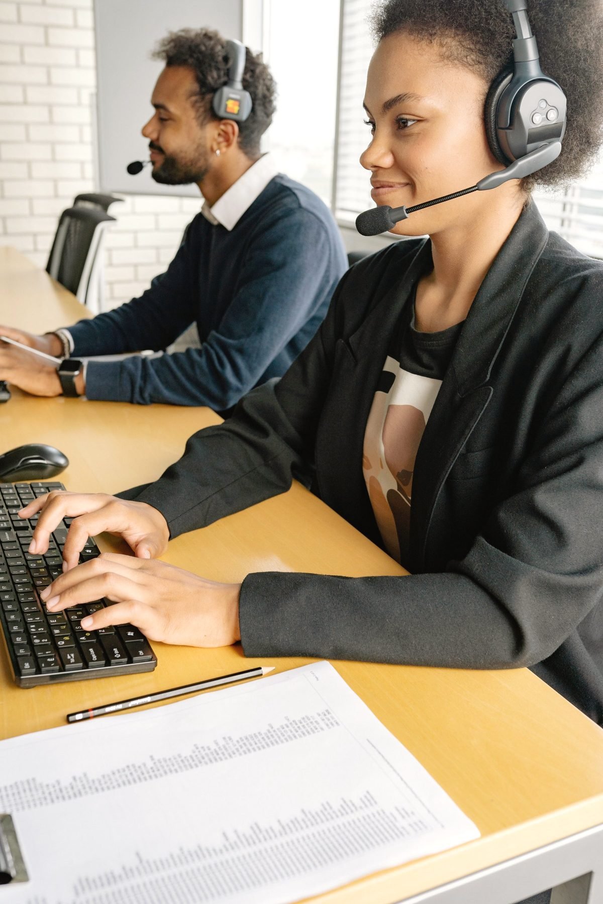 Operators working together at computers.