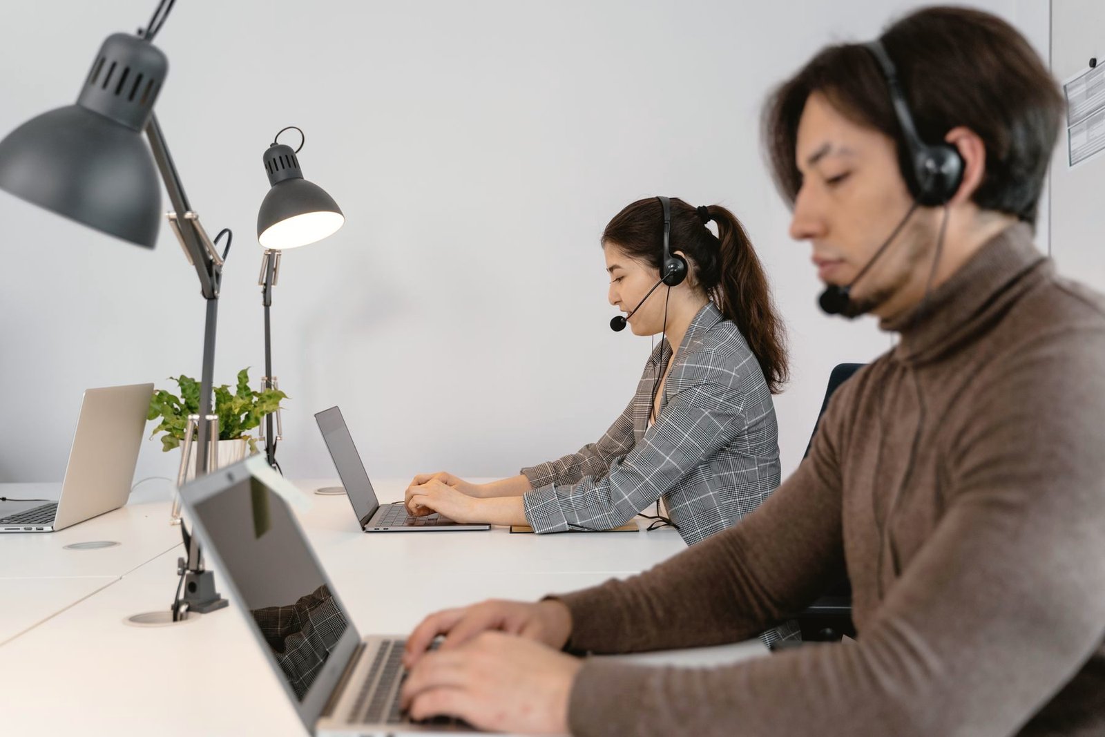 Operators working at laptops with headsets.