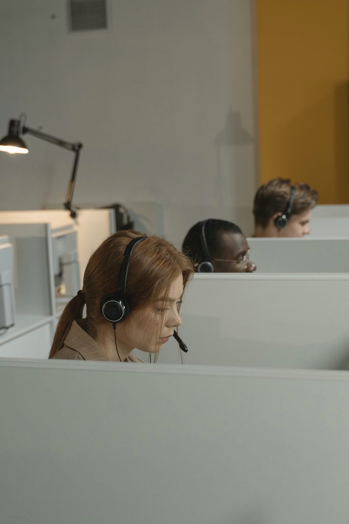Operators at a shared workspace handling calls.